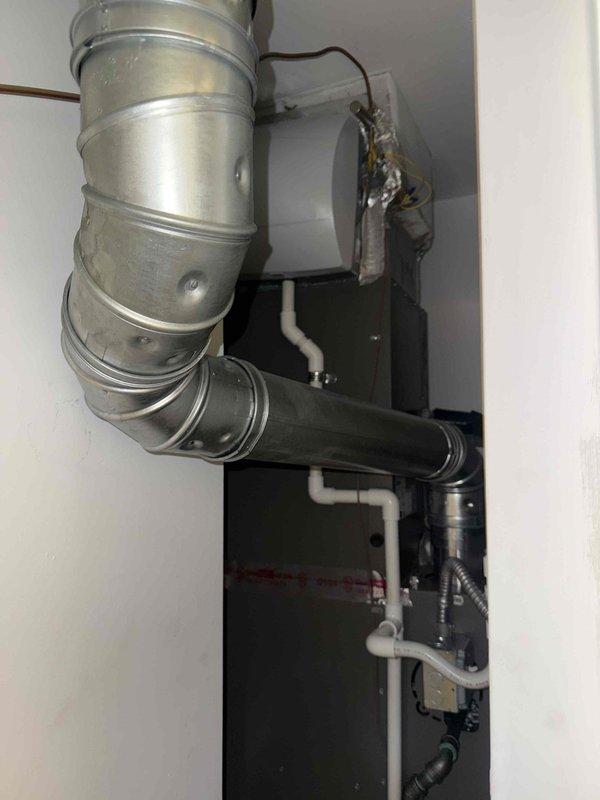 Responded to recall for ongoing condensate leak on 2-year-old AC unit located in utility room with mold and mildew growth present on equipment. Inspected air handler, condensate drain system, and evaporator coil assembly. Found condensate drain line improperly pitched causing water backup and accumulation on unit cabinet. Cleared primary drain line, verified proper drainage flow, and treated drain pan with antimicrobial solution to address existing mold growth. Recommended monitoring system over next cooling cycle to ensure leak is fully resolved and advised on preventive maintenance to avoid future microbial contamination.