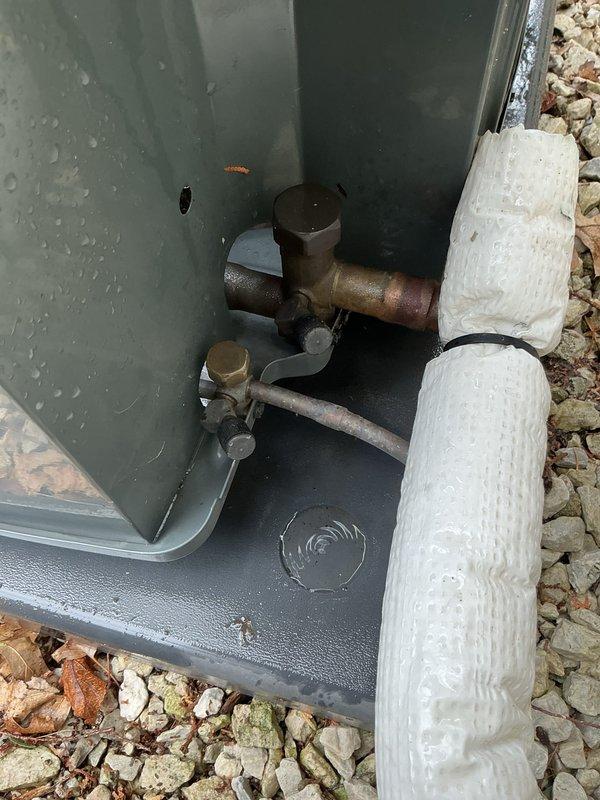 # HVAC Maintenance - Gold AC Inspection

Completed comprehensive annual tune-up and inspection on 5-year-old residential air conditioning system located in backyard. Performed standard preventive maintenance protocol including refrigerant level verification, electrical connection testing, condenser coil cleaning, and fan motor operation assessment. 

Upon arrival, conducted visual inspection of outdoor condensing unit and associated components. Inspected condenser fan assembly, noting normal wear consistent with unit age. Fan blades showed light dust accumulation on surfaces, which is typical for outdoor installations. Verified proper fan operation and motor function during system operation.

Examined refrigerant line set connections and insulation integrity. Noted significant corrosion present on copper refrigerant lines, particularly on horizontal pipe runs near service connections. Brass fittings showed oxidation and weathering from environmental exposure. White foam insulation on s