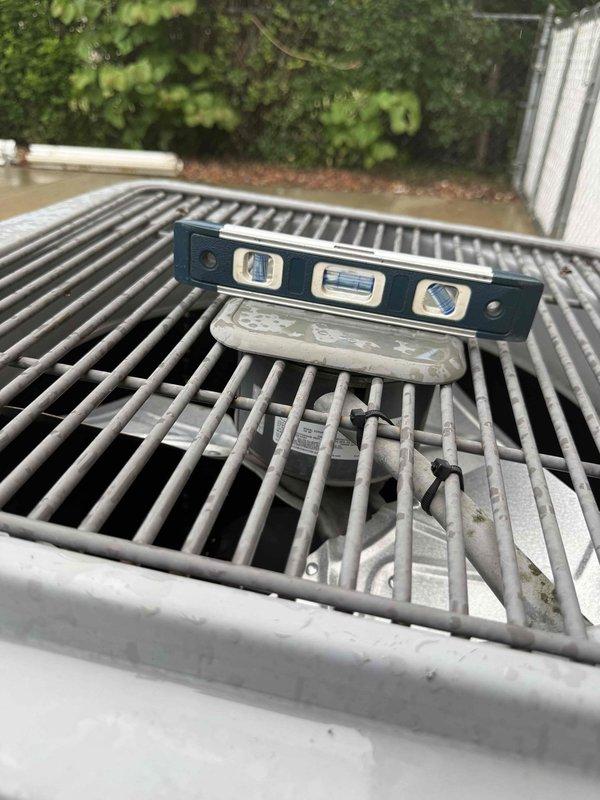 Completed Gold AC Inspection on 26-year-old air conditioning system with evaporator coil located in basement. Performed comprehensive evaluation including outdoor condensing unit levelness verification, electrical performance diagnostics using clamp meter to measure amperage draw and voltage readings, and visual inspection of all accessible components. Unit operational at time of inspection with electrical readings documented for baseline performance tracking.