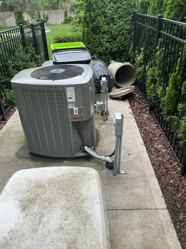 Excavated and installed new underground trench with PVC conduit to accommodate HVAC line sets for outdoor condensing unit. Routed refrigerant lines and electrical connections through protective piping, ensuring proper drainage and secure placement on concrete pad with appropriate clearances from residential fencing and landscaping.