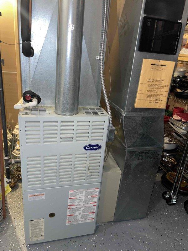 Completed comprehensive HVAC system replacement estimate for 25-year-old equipment consisting of furnace located in basement and air conditioning unit positioned outside. Assessed existing Carrier furnace installation, ductwork configuration including sheet metal plenums and flexible ducting, and outdoor condensing unit to provide replacement recommendations for complete heating and cooling system upgrade.