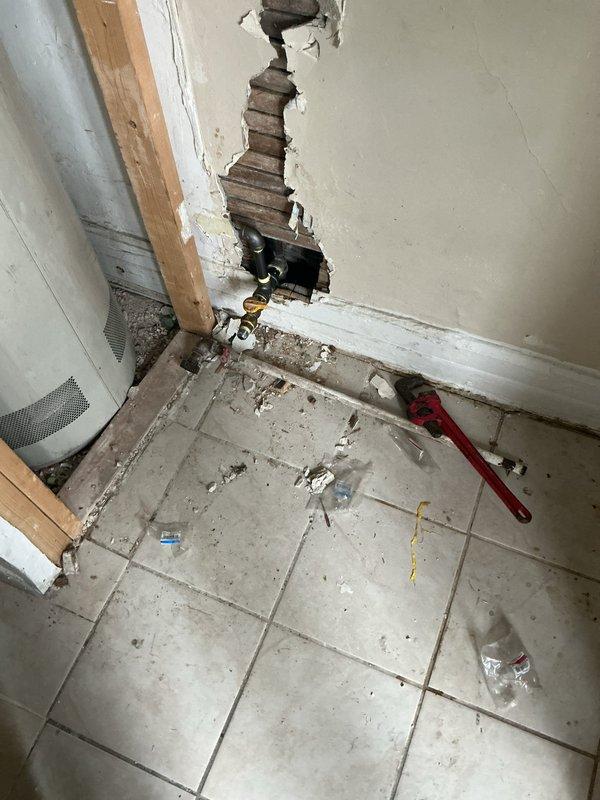 Responded to reports of a possible gas leak in the kitchen area of a 111-year-old residential property. Conducted comprehensive pressure testing on the kitchen gas line to identify the source of the suspected leak that had been ongoing for approximately one month. Testing required accessing gas supply lines behind wall surfaces, necessitating removal of drywall sections to expose piping for thorough inspection. Performed systematic pressure test protocol on all accessible gas line segments serving the upstairs kitchen area. Inspected gas furnace connections and related gas distribution lines in the basement utility area to rule out any secondary leak points in the system. All testing procedures followed current safety standards and code requirements for gas line integrity verification. Documented findings with photographic evidence of accessed areas and testing points for service records.