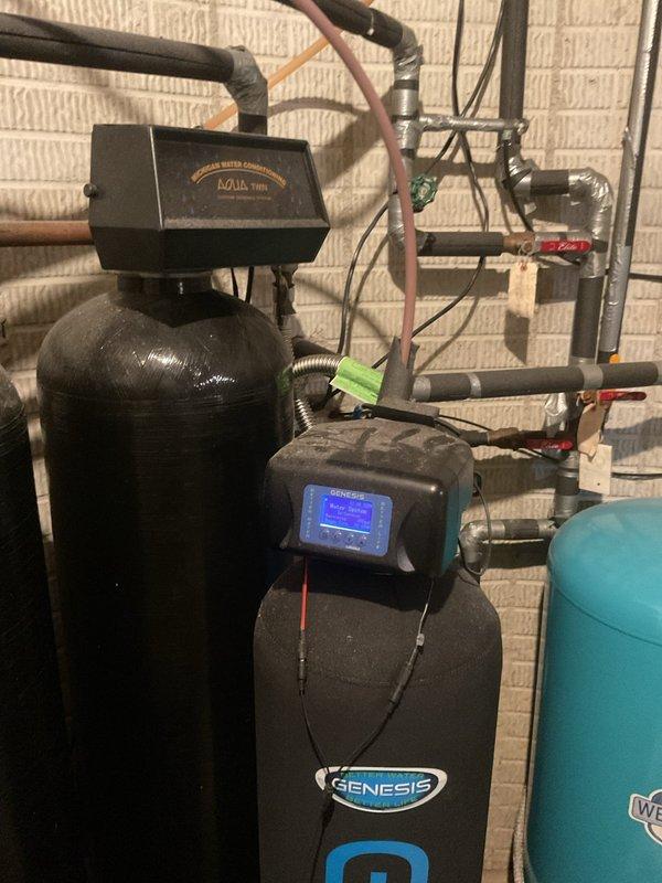 Assessed existing radiant floor heating system that was previously installed but never connected or commissioned. Inspected system components and determined requirements for connecting to existing water heater located in commercial space. Identified need for thermostat installation and associated connectors to complete the system hookup. Documented current water treatment equipment including water softener and filtration system, along with existing HVAC evaporator coil assembly with copper refrigerant lines and heat exchanger. Evaluated plumbing infrastructure and provided estimate for necessary connections, controls, and startup procedures to make radiant heating system operational.