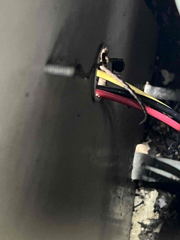 Responded to service call for non-operational air conditioning unit with reported unusual noise and visible wiring damage. Upon arrival, inspected 23-year-old outdoor condensing unit and identified severely deteriorated electrical connections with exposed and damaged wiring at the contactor assembly. Found evidence of arcing and heat damage at wire terminals, along with significant corrosion on metal components throughout the unit due to age and weather exposure. Documented hazardous electrical conditions with photographs showing frayed wires and compromised connections that posed safety risk. Unit was deemed unsafe for operation and customer was advised to shut down system immediately to prevent potential electrical fire or further equipment damage. Recommended complete electrical component replacement and full system evaluation given the age of the equipment and extent of deterioration observed.