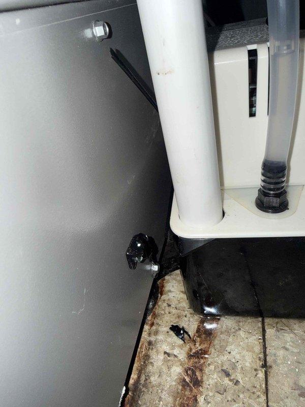Responded to service call for water leakage on newly installed air conditioning system located in basement. Upon inspection, identified improperly pitched condensate drain line causing water to back up and overflow onto floor, resulting in visible staining on tile surface. Corrected PVC drain line pitch to ensure proper gravity drainage, verified condensate pump operation and float switch functionality, and tested system through complete cooling cycle. Confirmed all condensate properly draining with no further leakage detected.