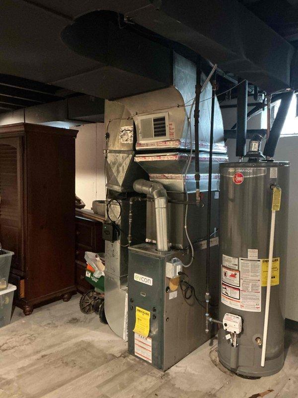 Completed installation of a 2-ton air conditioning system with matching evaporator coil in residential basement utility area. Installed new air handler unit with proper ductwork connections, condensate drain lines using white PVC piping, and established new dedicated electrical circuit to code. Coordinated mechanical and electrical permits, positioned outdoor condenser unit in rear yard, and ensured all components are operational and meet manufacturer specifications.