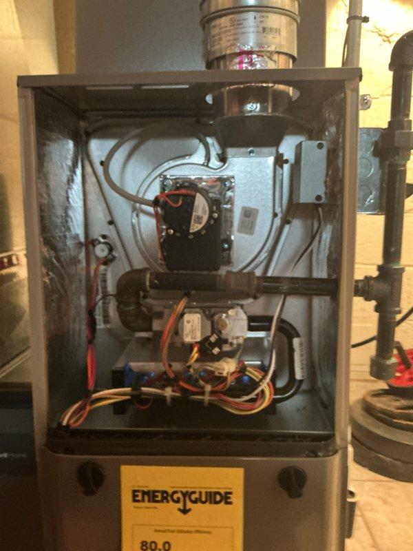 Completed comprehensive Gold AC Inspection on 2-year-old residential cooling system. Performed full tune-up on outdoor condenser unit, inspecting fan motor assembly, electrical connections, and refrigerant levels. Verified proper airflow through coil fins and checked compressor operation. Inspected indoor furnace blower motor and electrical wiring harnesses, confirming all connections secure and components operating within specifications. Cleaned condenser coils, checked voltage and amperage readings at both units, and tested thermostat communication. All systems found operating efficiently with no deficiencies noted. Unit showing normal wear consistent with age, with all safety controls functioning properly. Documented equipment condition with photos of both indoor furnace cabinet and outdoor condenser unit for maintenance records.