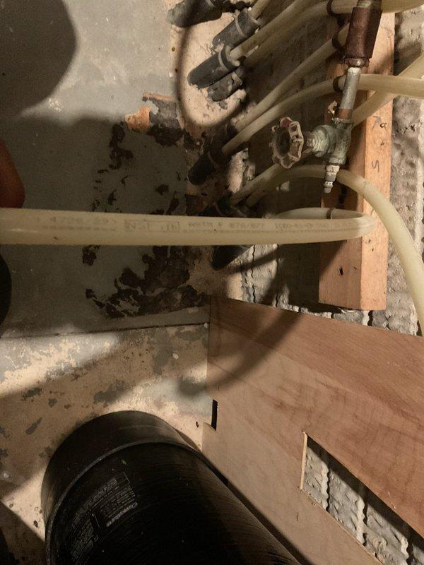 Responded to a basement drain backup causing significant flooding in the lower level. Upon arrival, found standing water covering multiple areas of the basement floor, affecting storage space and personal belongings. Accessed the main drainage system through the basement utility area, inspecting the plumbing infrastructure including PEX water lines, copper fittings, and drain pipes mounted along floor joists. Identified and cleared the blockage in the main drain line, restoring proper drainage flow. Verified system operation and confirmed water was draining correctly through all basement fixtures.