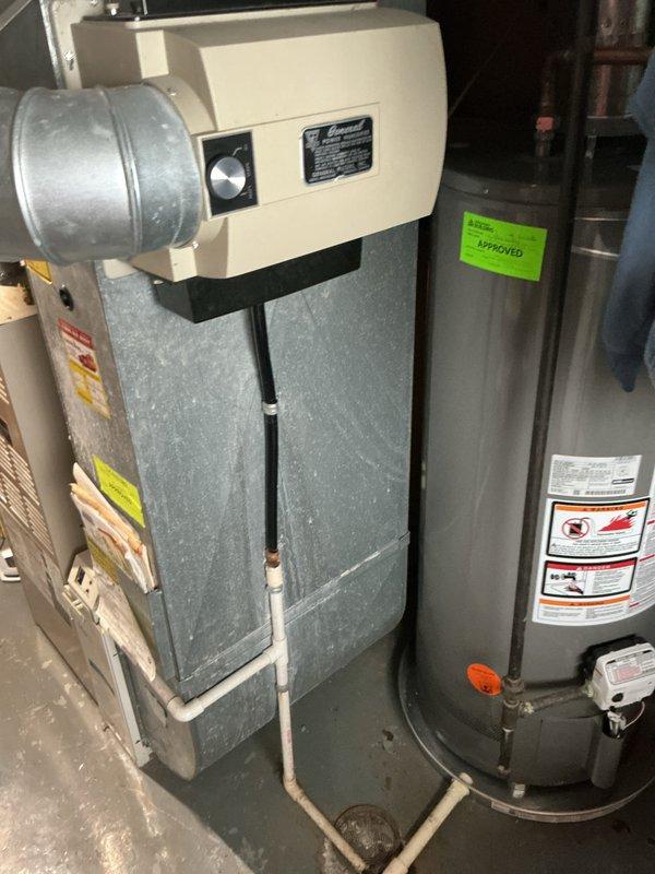 Conducted on-site evaluation for complete air conditioning system replacement of 30-year-old outdoor Lennox condenser unit. System had been previously flagged for replacement during summer inspection due to age and declining efficiency. Documented existing equipment configuration including outdoor condensing unit positioned on gravel pad adjacent to residence with refrigerant lines running along exterior wall, and indoor air handler/furnace unit located in basement utility area with associated ductwork and PVC condensate drainage. Photographed current system components and installation layout to provide comprehensive visual documentation for replacement proposal. Assessed electrical service connections, refrigerant line routing, condensate drainage pathways, and clearance requirements for new equipment installation. Evaluated existing ductwork connections and determined compatibility requirements for new system integration. Provided detailed replacement estimate including equipment spe