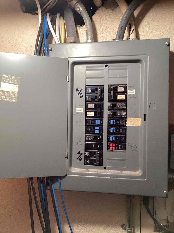 Responded to no cooling complaint on residential air conditioning system. Evaluated 10+ year old Lennox condenser unit located at exterior of property and assessed attic-mounted air handler accessible through bedroom door. Inspected electrical service panel and outdoor condensing unit to determine system condition and operational status. Documented equipment configuration and current state of HVAC components. Provided comprehensive full system replacement estimate for two complete HVAC systems due to age and condition of existing equipment.