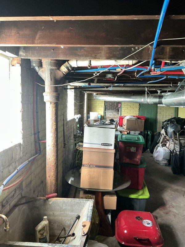 Responded to active water leak in bathroom with visible dripping, wall sweating, and paint deterioration near ceiling area. Conducted thorough inspection of plumbing infrastructure in basement area, examining exposed piping systems including PEX water lines, supply pipes, and potential condensation sources affecting the bathroom above. Identified moisture intrusion pattern consistent with plumbing leak or excessive condensation in aging residential structure, documented conditions with photographic evidence, and provided assessment of affected areas requiring remediation to prevent further water damage and structural deterioration.