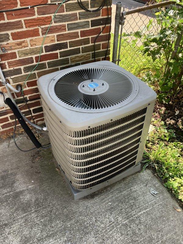 Conducted comprehensive site evaluation for replacement estimate of 15-year-old residential air conditioning system located in backyard. Assessed existing condensing unit positioned on concrete pad against brick exterior wall, documented current equipment condition including condenser coil integrity and cabinet weathering, evaluated electrical service infrastructure including meter location and existing conduit routing, and photographed installation area to develop accurate replacement specifications for owner-occupied property.