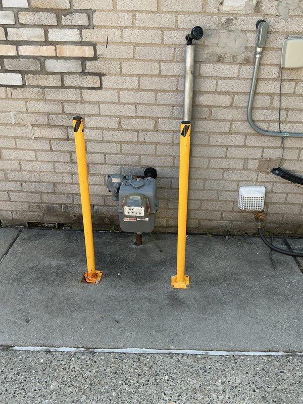 Conducted comprehensive site evaluation for whole home generator installation at residential property. Assessed existing electrical panel configuration, circuit breaker capacity, and available space for transfer switch integration. Evaluated natural gas meter location and utility infrastructure to determine optimal generator placement and fuel line routing. Documented protective bollard clearances and verified adequate space for generator unit installation while maintaining required utility access and safety zones.