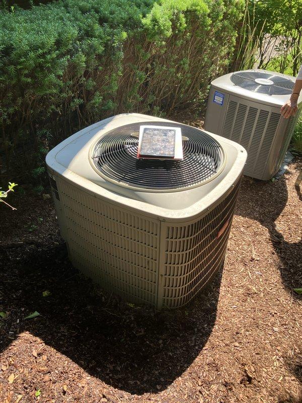 Provided comprehensive replacement estimate for 20-year-old air conditioning system currently located on exterior right side of property near rear of home. Evaluated existing operational AC condenser unit and compatible natural gas furnace system, assessed current Bryant Evolution thermostat integration, and documented equipment specifications and site conditions including adequate clearance in landscaped area with multiple existing units present. Presented replacement options for complete HVAC system upgrade to improve efficiency and reliability.