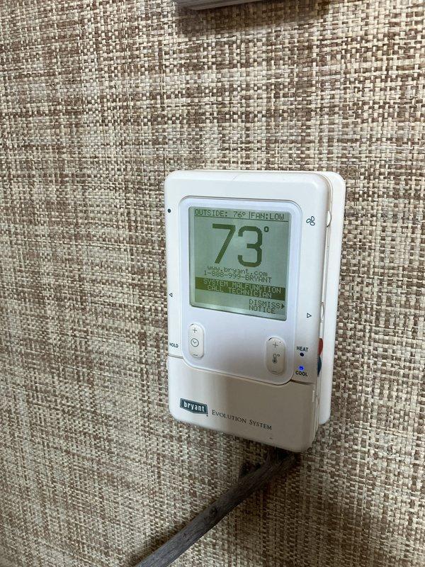 Provided comprehensive replacement estimate for 20-year-old air conditioning system currently located on exterior right side of property near rear of home. Evaluated existing operational AC condenser unit and compatible natural gas furnace system, assessed current Bryant Evolution thermostat integration, and documented equipment specifications and site conditions including adequate clearance in landscaped area with multiple existing units present. Presented replacement options for complete HVAC system upgrade to improve efficiency and reliability.