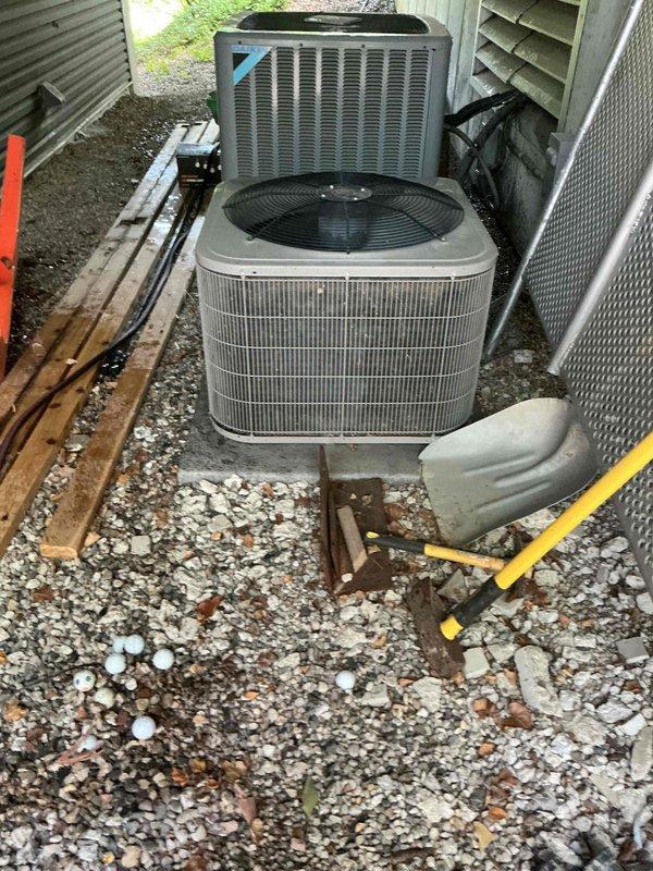 Responded to service call for central air conditioning system producing abnormal operating sounds. Performed comprehensive annual maintenance inspection on outdoor condensing units. Examined both AC units on-site, checking refrigerant levels, electrical connections, and mechanical components. Verified system operational status and cooling capability. Cleaned condenser coils, inspected fan motors and blades for proper operation, and tightened all electrical connections. Assessed gravel pad stability and unit mounting. System restored to normal operating parameters with no unusual noise detected upon completion. Recommended continued annual maintenance schedule to ensure optimal performance and longevity.