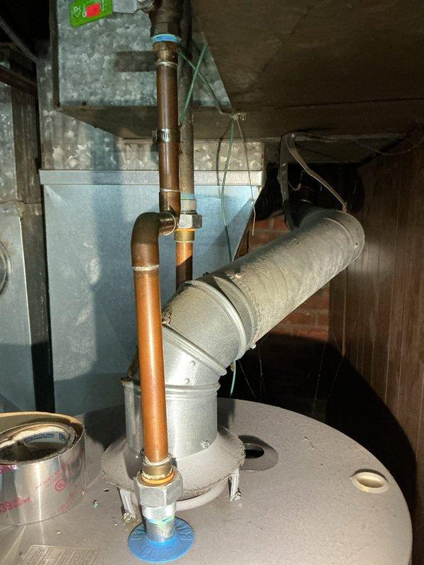 Responded to a basement water heater leak call. Upon inspection, found active leaking at the base of the tanked water heater with visible water staining on the concrete floor. Assessed the unit's condition, including all copper piping connections, pressure relief valve, and tank integrity. Documented the leak source and current installation setup, including connection points and surrounding plumbing infrastructure. Provided diagnostic findings and recommendations to the property owner for necessary repairs or replacement options.