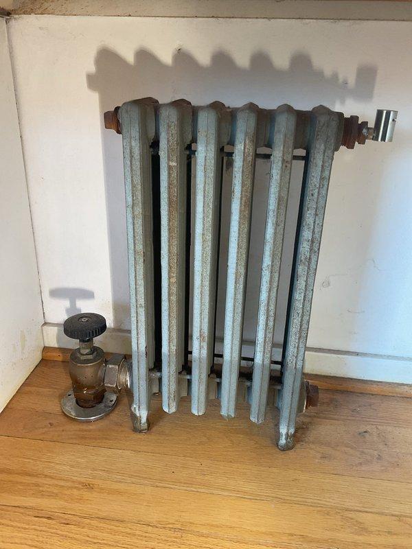 Completed site assessment for radiator relocation from kitchen to dining room. Disconnected 10+ year old six-column radiator from existing supply and return lines, capped connections at original location in kitchen. Evaluated basement mechanical room and existing piping infrastructure to determine routing requirements for new installation location in dining room.