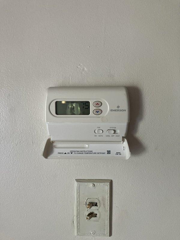 Responded to water leak from basement air conditioning unit draining onto floor instead of into designated tub. Evaluated aging AC system that was still providing cooling despite drainage issue. Assessed existing Emerson thermostat, electrical panel configuration, and overall system condition to provide comprehensive estimate for full HVAC system replacement given age of equipment and current drainage failure.
