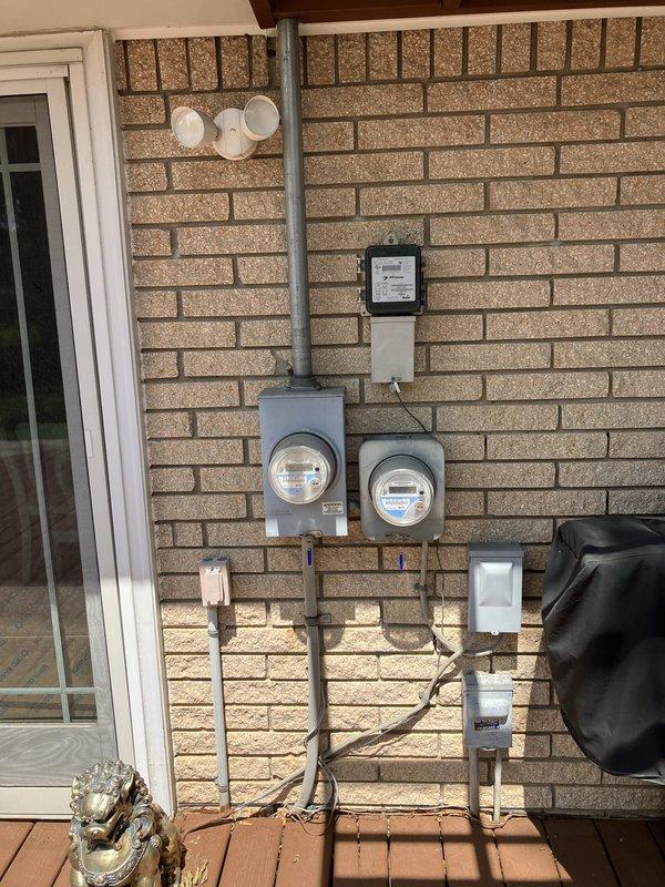 Conducted on-site assessment for new whole home generator installation at residential property. Evaluated existing electrical service configuration including dual meter setup with gray protective enclosures, conduit routing, and disconnect panel mounted on exterior brick wall. Inspected electrical infrastructure capacity and determined optimal generator placement considering accessibility for utility connection, fuel source routing, and clearance requirements from building structure. Documented current electrical service entry point, meter configuration, and available space on wooden deck area for equipment installation. Provided estimate for complete whole home generator system including necessary transfer switch, electrical connections, and integration with existing residential electrical panel.