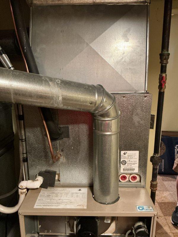 Responded to urgent service call for non-operational furnace system affecting whole-house heating and cooling capabilities. Assessed 35-year-old original equipment installed in 1991, located in basement mechanical room. Documented existing furnace installation including cabinet unit, ductwork connections, filter housing, and associated copper and brass piping components. Provided comprehensive replacement estimate for complete HVAC system replacement due to equipment age and failure affecting both heating and air conditioning functionality.