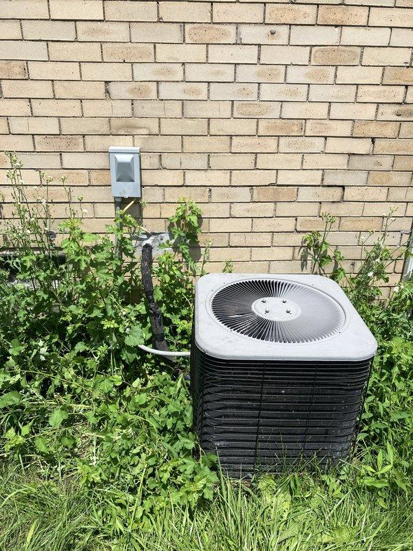 Responded to service call for non-operational central air conditioning system. Upon inspection, discovered outdoor condensing unit with R22 refrigerant had completely depleted refrigerant charge, rendering system inoperable. Assessed existing Goodman furnace and AC system configuration in basement mechanical room and exterior location. Provided comprehensive replacement estimate for new HVAC system due to obsolete R22 refrigerant and complete loss of cooling capacity.