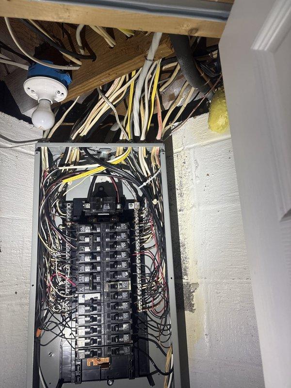 Responded to service call for damaged electrical panel box requiring repair or replacement. Upon inspection, found electrical panel housing with compromised mounting or structural damage. Assessed panel condition, verified circuit breaker functionality, and examined wire connections for safety concerns. Secured panel box mounting to wall, ensured proper grounding and bonding connections, and verified all circuit breakers were properly seated and operational. Confirmed all electrical wiring entering panel from ceiling joists maintained proper strain relief and code-compliant installation. Tested panel integrity and verified safe operation of electrical system upon completion.
