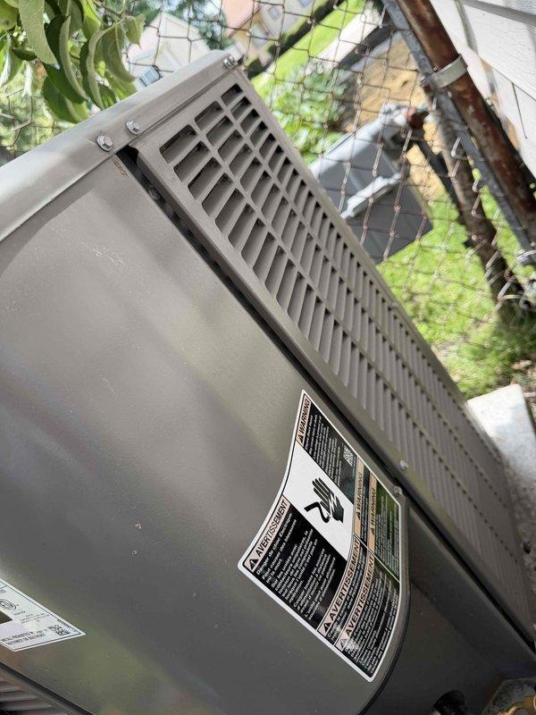 Responded to no cooling complaint on 4-year-old residential AC system with freezing coil condition. Upon arrival, performed comprehensive diagnostic evaluation of outdoor condensing unit and connected refrigerant monitoring equipment to assess system pressures and temperatures. Digital gauge readings revealed abnormal operating parameters consistent with restricted airflow or low refrigerant charge causing evaporator coil icing. Inspected outdoor unit for proper operation, verified electrical connections, and assessed refrigerant line insulation integrity. Documented equipment condition through photographic evidence showing unit placement in basement with outdoor condenser positioned in residential backyard setting. System requires further evaluation of indoor evaporator coil, airflow restrictions, and potential refrigerant leak to resolve freezing issue and restore proper cooling operation.