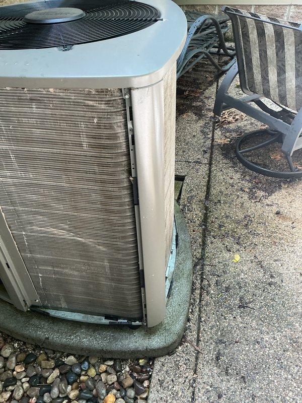 # HVAC Maintenance - Gold AC Inspection

Performed comprehensive annual maintenance on a 3-year-old residential air conditioning system located in the backyard. Conducted complete system inspection including electrical connections, refrigerant levels, and component operation verification. Noted significant exterior dirt and grime accumulation on condenser unit panels requiring attention during service.

Inspected condenser unit thoroughly, checking fan motor operation, blade assembly integrity, and protective grille condition. Verified proper airflow through condenser coils despite visible dust and debris buildup on exterior metal fins. Tested capacitor performance and measured voltage and amperage readings to ensure system operating within manufacturer specifications.

Examined condensate drain pan and base mounting for proper positioning and drainage. Confirmed unit secured on concrete pad with appropriate vibration dampening. Checked refrigerant pressures on both high and low sides,
