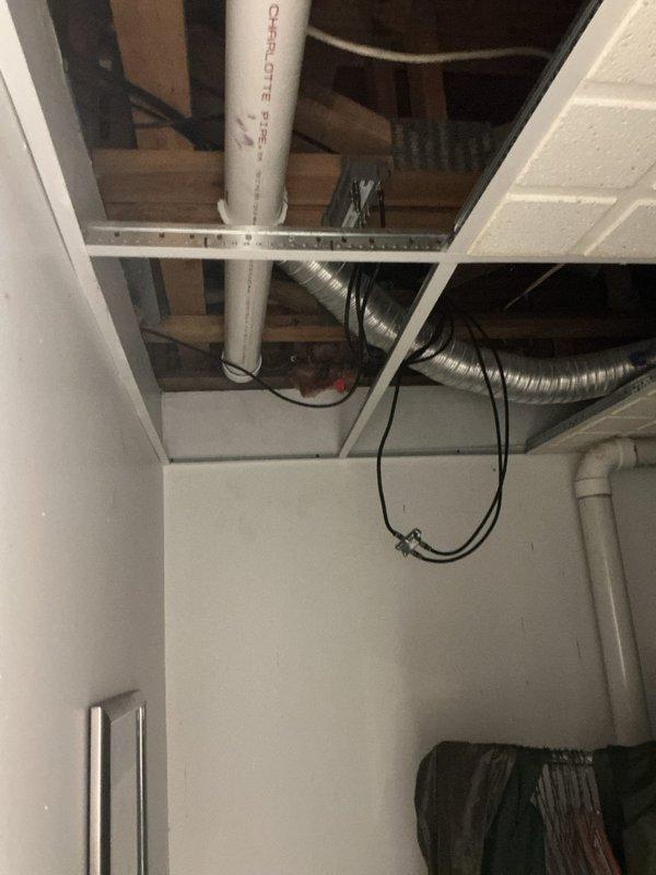 Installed 75-gallon power vent water heater in basement utility area. Completed all necessary venting connections using PVC piping routed through ceiling joists to exterior, installed electrical connections, and established water supply lines to new unit. Unit positioned on concrete floor with proper clearances maintained for ventilation and service access.