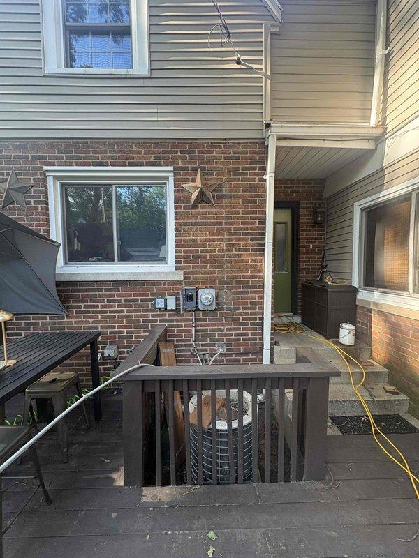 Reinstalled electrical circuit box on exterior brick wall following storm damage. Ran new conduit lines from circuit box to service connector using flexible metal armored cable, securing all connections per code requirements. Restored proper electrical service configuration with all components properly mounted and grounded.