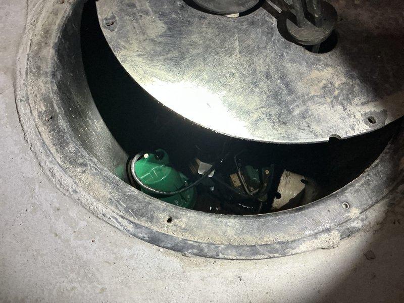 Responded to basement sump pump system experiencing battery backup alarm activation and grinding/squealing noise during pump test cycle. Accessed concrete sump basin and inspected dual pump configuration including primary pump and battery backup system. Diagnosed mechanical failure in primary sump pump causing abnormal operating sounds and triggering backup system alarm. Removed defective pump unit, verified proper float switch operation, and confirmed discharge piping and exterior backflow prevention assembly functioning correctly.