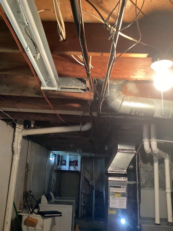 Performed comprehensive inspection of 17-year-old R22 cooling system located in basement. Evaluated existing HVAC equipment including furnace, air handler, and associated ductwork to provide replacement estimate. Documented current system configuration, including flexible ductwork installation, PVC condensate drainage, and overall equipment condition to determine complete replacement requirements for aging refrigerant system.