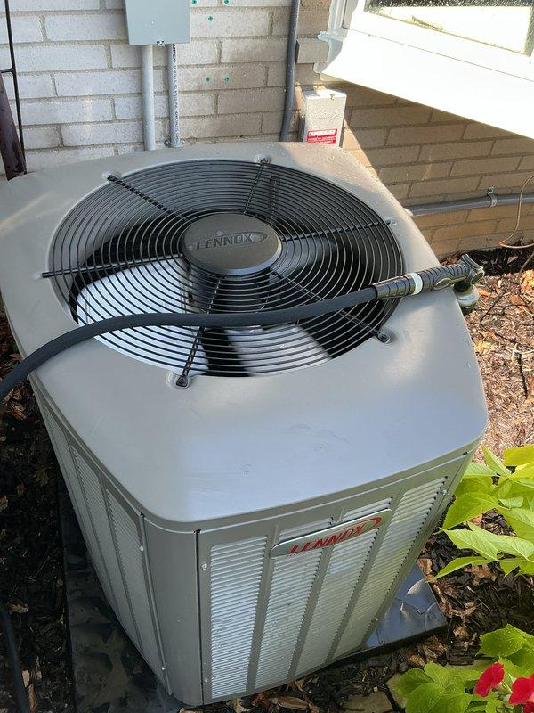 Completed comprehensive Gold AC inspection on 2025 Lennox outdoor condensing unit and basement-located air handler system. Performed visual inspection of condenser cabinet, fan assembly, and refrigerant line connections, confirming unit operational status and proper mounting. Documented equipment condition with photos showing well-maintained condenser on concrete pad with intact cabinet finish and clean fan grille, plus basement mechanical room housing Noritz tankless water heater and associated HVAC components. All systems confirmed operational by homeowner prior to inspection, with single-zone configuration verified and equipment showing no visible signs of wear or damage.