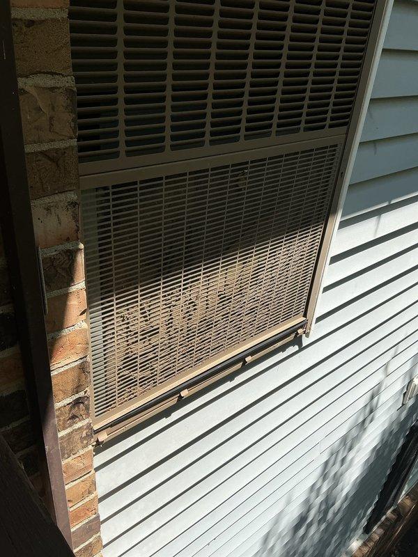 Responded to no air flow complaint on 4-year-old residential air conditioning system located in office/second bedroom. Performed diagnostic evaluation of outdoor condensing unit mounted on exterior wall. Inspected unit housing, louvers, and ventilation grilles for obstructions or damage. Verified proper airflow through condenser coils and assessed overall system operation to restore cooling capacity.