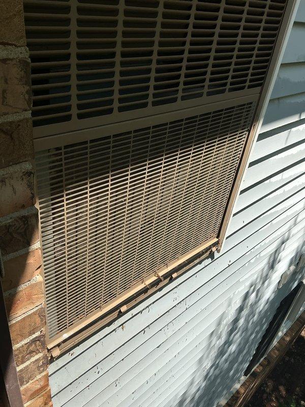 Responded to no air flow complaint on 4-year-old residential air conditioning system located in office/second bedroom. Performed diagnostic evaluation of outdoor condensing unit mounted on exterior wall. Inspected unit housing, louvers, and ventilation grilles for obstructions or damage. Verified proper airflow through condenser coils and assessed overall system operation to restore cooling capacity.