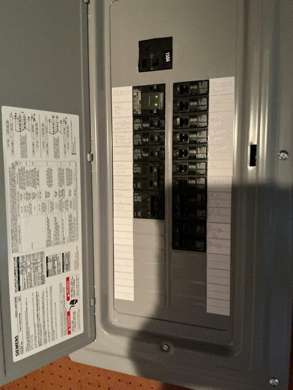 Installed a new Siemens 150-amp main breaker panel with a 150-amp main disconnect in the basement utility area. The panel was mounted on pegboard wall with proper clearances, featuring two vertical columns of circuit breakers with appropriate labeling and circuit directory documentation affixed to the interior door. All electrical connections were completed to code specifications, with the service entrance conductors properly terminated and the grounding system established per NEC requirements.