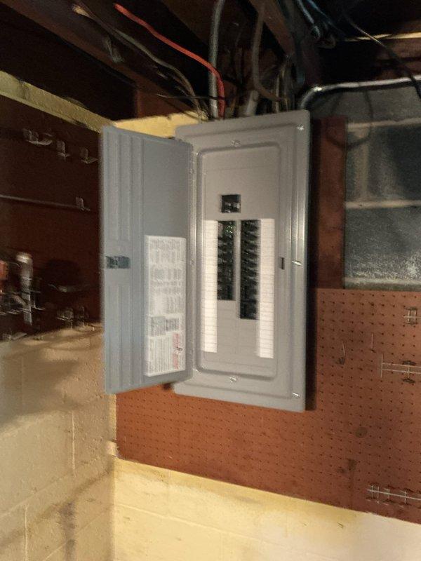 Installed a new Siemens 150-amp main breaker panel with a 150-amp main disconnect in the basement utility area. The panel was mounted on pegboard wall with proper clearances, featuring two vertical columns of circuit breakers with appropriate labeling and circuit directory documentation affixed to the interior door. All electrical connections were completed to code specifications, with the service entrance conductors properly terminated and the grounding system established per NEC requirements.