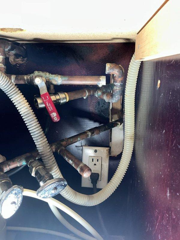 Removed wall-mounted shower valve unit with vertical panel system from master bathroom shower enclosure and temporarily capped supply line ends. Installed connection point for air compressor at boiler drain near meter to facilitate whole-house pressure testing. Performed comprehensive pressure test on entire plumbing system to identify leaks and pressure loss issues. Completed minor plumbing repairs as identified during testing process, including addressing corroded copper pipe connections and shut-off valve issues observed in under-sink plumbing areas. Coordinated arrival time for access to unoccupied property, with water service restoration scheduled for later phase pending results of pressure testing and any additional repairs required beyond initial scope.