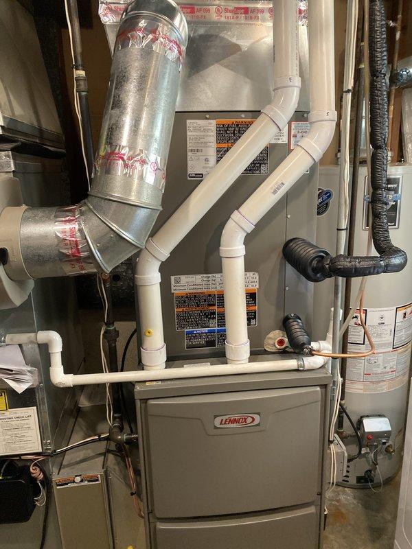 Successfully completed installation of 2.5-ton air conditioning system with evaporator coil in rear yard location. Installed new Lennox furnace with A-coil in interior utility space, including proper condensate drain lines using PVC piping, flexible ductwork connections, and all required venting. Exterior condenser unit positioned on concrete pad in backyard with refrigerant lines reconnected and system charged to manufacturer specifications. All mechanical components installed per code requirements with permit requested for inspection.
