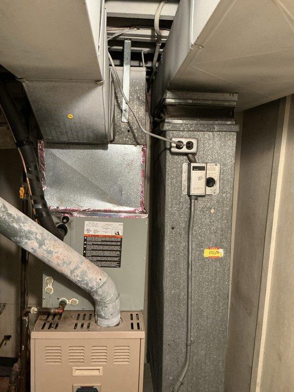 Responded to service call for 15-year-old air conditioning system that was running but not cooling. Upon inspection, confirmed unit was an R22 refrigerant system with no refrigerant charge remaining in the system. Documented existing indoor air handler and furnace configuration, as well as electrical panel setup. Due to the age of the equipment, obsolete R22 refrigerant requirement, and complete loss of refrigerant indicating likely system leak, provided estimate for full HVAC system replacement rather than repair of existing unit.