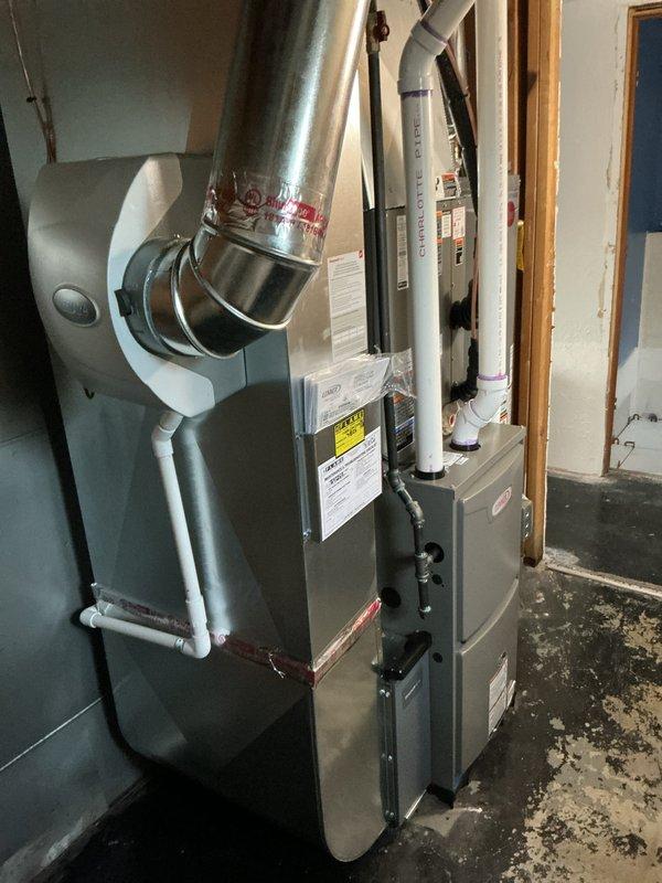Completed full HVAC system installation including a 70,000 BTU furnace and 2.5-ton air conditioning unit in left side yard location. Obtained mechanical and electrical permits prior to installation. Installed new furnace with proper venting using white PVC piping, connected ductwork with metallic supply plenum, and positioned unit in basement utility area. Installed 2.5-ton condensing unit in side yard with reconnection of refrigerant lines. Performed system startup, charged refrigerant to manufacturer specifications, and verified proper pressures using digital manifold gauges showing 134.0 psig low side and 798.8 psig high side. Completed all electrical connections, tested system operation, and confirmed proper airflow and temperature differentials. Customer qualifies for utility rebate program. All work completed to code with required permits.
