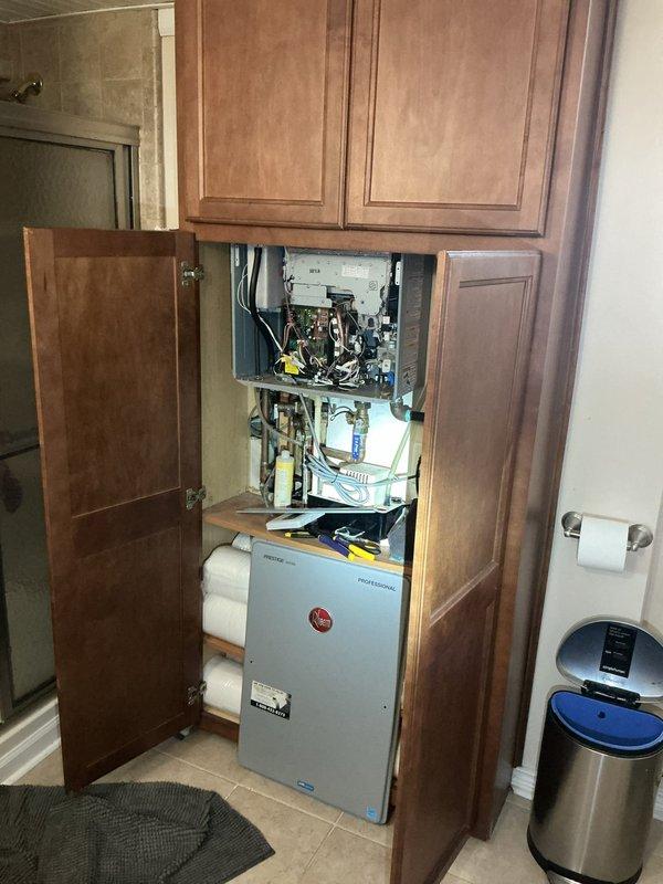 Responded to Rheem tankless electric water heater displaying error code 29, resulting in loss of hot water to entire residence. Unit had been powered off at breaker by homeowner prior to arrival. Performed diagnostic evaluation and determined error code was triggered by mineral buildup and scale accumulation within heat exchanger due to overdue maintenance flush (last service performed over one year prior). Executed complete descaling procedure using vinegar solution flush of heat exchanger and internal components. Cleared condensate drainage system which showed signs of restriction. Reset error codes, restored power, and cycled unit through multiple heating cycles to verify proper operation. Confirmed hot water delivery restored to all fixtures throughout home. Advised homeowner on recommended annual maintenance schedule to prevent future scale-related error codes and maintain manufacturer warranty compliance on unit less than two years old.