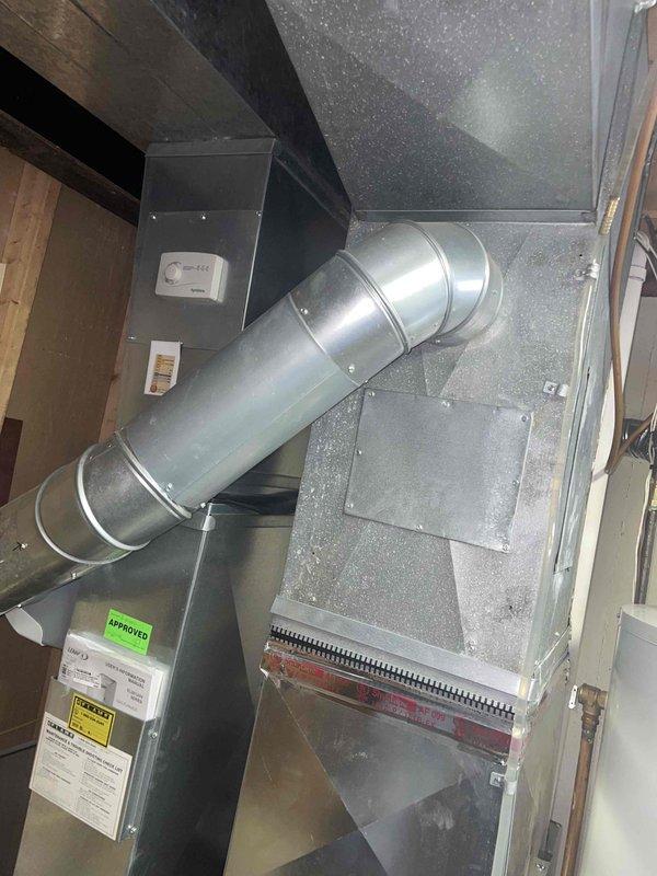 Conducted comprehensive HVAC system evaluation on 15-year-old residential air conditioning system with basement-located air handler and outdoor condenser unit. Assessed equipment condition, ductwork integrity, and overall system performance to provide replacement estimate for non-operational air conditioning system. Documented existing installation including galvanized metal ductwork configuration, air handler cabinet with associated components, and outdoor condenser unit positioned on concrete pad with proper electrical disconnect.