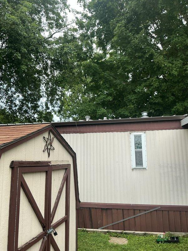 Responded to service call for mobile home water heater with pilot light failure. Upon inspection, confirmed concerns raised by utility company regarding improper installation and ventilation configuration in crawl space. Documented existing conditions showing water heater installation beneath structure with questionable venting arrangement and accessibility issues. Photographed exterior property access point and crawl space area revealing substandard installation practices including compromised insulation, inadequate clearances, and ventilation components not meeting mobile home water heater code requirements. Flagged unit for immediate attention due to safety concerns and recommended consultation with management regarding installation deficiencies and potential recall status.