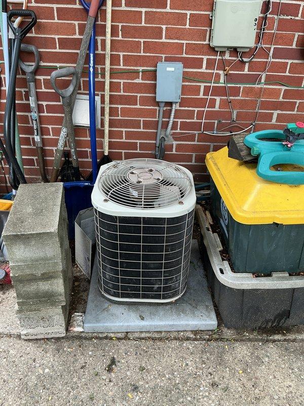 Conducted whole-home HVAC replacement estimate for existing furnace and air conditioning system. Inspected basement-located furnace and outdoor condensing unit positioned on concrete pad against building exterior, documented current equipment configuration including electrical connections, disconnect switches, and conduit routing. Provided customer with replacement options and recommendations for complete system upgrade.