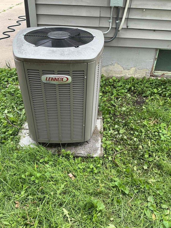 Performed comprehensive AC tune-up on 6-year-old Lennox condensing unit located in backyard. Conducted full system inspection including visual assessment of cabinet condition, checked electrical connections and conduit, verified proper unit leveling on concrete pad, and inspected condenser coil through louvers. Measured refrigerant charge using digital scale to ensure system operating at manufacturer specifications. Unit found in good operating condition with no issues identified. System operating efficiently with all components functioning within normal parameters.