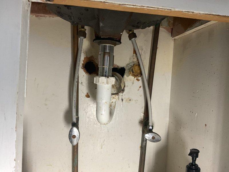 Responded to a toilet tank leak that had been occurring for approximately 25 days. Upon arrival, found that the homeowner had attempted to replace a faulty fill valve but was unable to remove the corroded tank mounting bolt. Successfully removed the seized bolt from beneath the tank, replaced the defective fill valve assembly, and restored proper tank function. Addressed significant rust staining and mineral buildup observed inside the tank during the repair. Additionally installed a new bathroom faucet and shower arm as requested. All fixtures tested and confirmed operational with no leaks detected upon completion.
