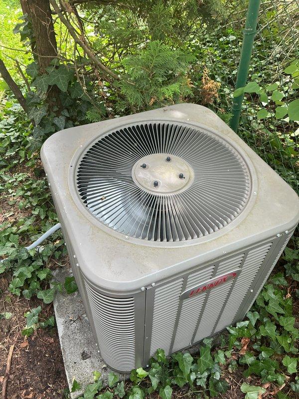 Completed comprehensive Gold AC inspection on dual-zone residential system with 2018 equipment featuring first floor and basement mini-split air handlers. Inspected outdoor condenser unit, verified operational status of both zones, documented equipment condition with vegetation encroachment noted around outdoor unit requiring clearance maintenance for optimal airflow and efficiency.