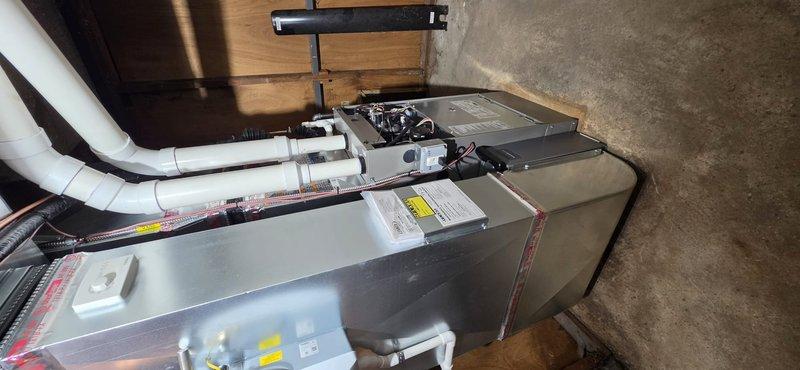 Completed full HVAC system replacement including 90,000 BTU furnace and 3-ton air conditioning unit in rear yard location. Installed Ecobee 3 Lite thermostat, humidifier, condensate pump, and base pad for outdoor equipment. Ran new refrigerant lines with proper insulation, installed white PVC condensate drain lines, and completed all electrical connections at the circuit breaker panel. Performed mechanical and electrical permit work, reconnected all system components, and remeasured supply air for proper airflow. System tested and operational with all safety labels and manufacturer documentation in place.